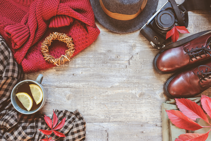 autumn women fashion clothes set with cozy sweater, shoes, plaid shirt, vintage photo camera, hat and cup of tea. Fall seasonal walk concept, flat lay with empty space