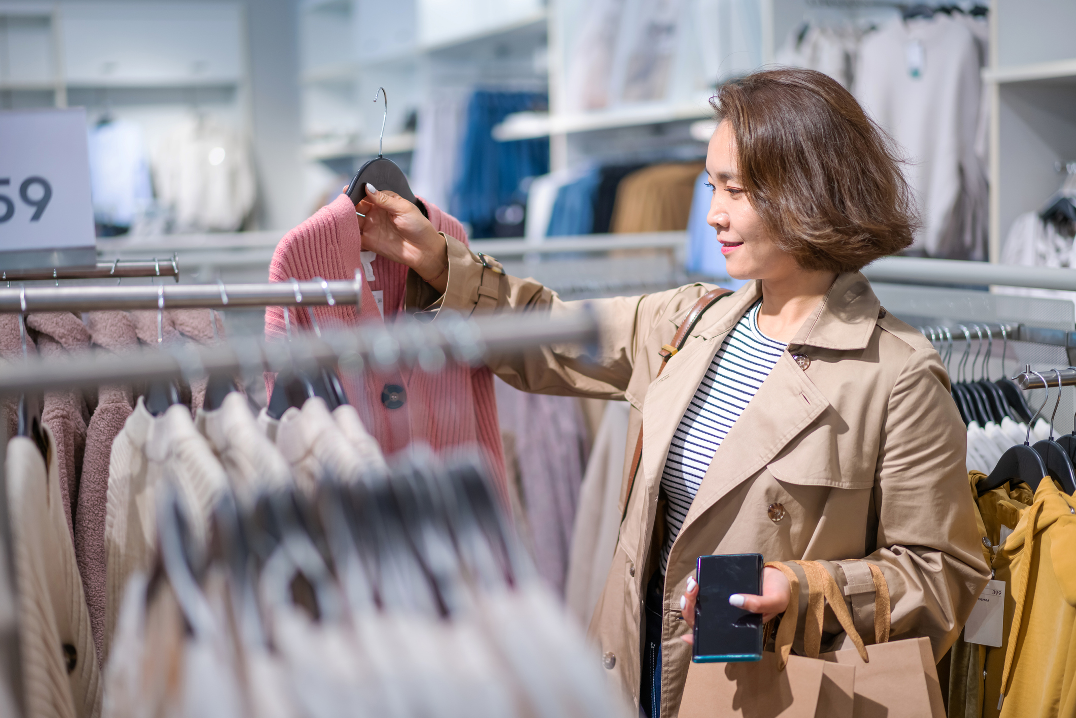 Young Asian women buying clothes